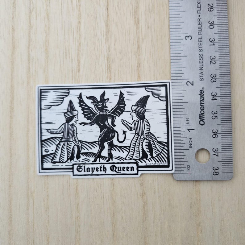 May include: Black and white sticker featuring a stylized illustration of a devil figure with two figures in robes. The sticker has the text "Slayeth Queen" at the bottom. The sticker is approximately 2 inches long.