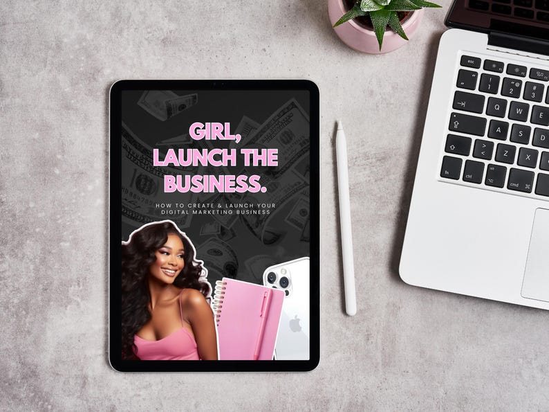May include: A digital marketing business guide displayed on a tablet. The tablet screen features the text "GIRL, LAUNCH THE BUSINESS." and an image of a woman. A laptop, stylus, and plant are also visible.