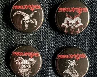 May include: Four black circular badges with the word "Proclamation" in red gothic lettering. Each badge features a different white illustration of a skull with horns and other occult symbols. The badges are on a dark blue denim surface.