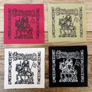 May include: Four square patches featuring the word "CONQUEROR" and a knight on horseback design. The patches are in red, light green, white, and black, with a skull border.