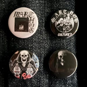 May include: Four round buttons with gothic-style illustrations. One button features the text "WARTHOG" and a square design. Another has "MARTHOG" and "CULTURE?" text with a skeletal figure. The other two buttons have skull and horror-themed graphics.
