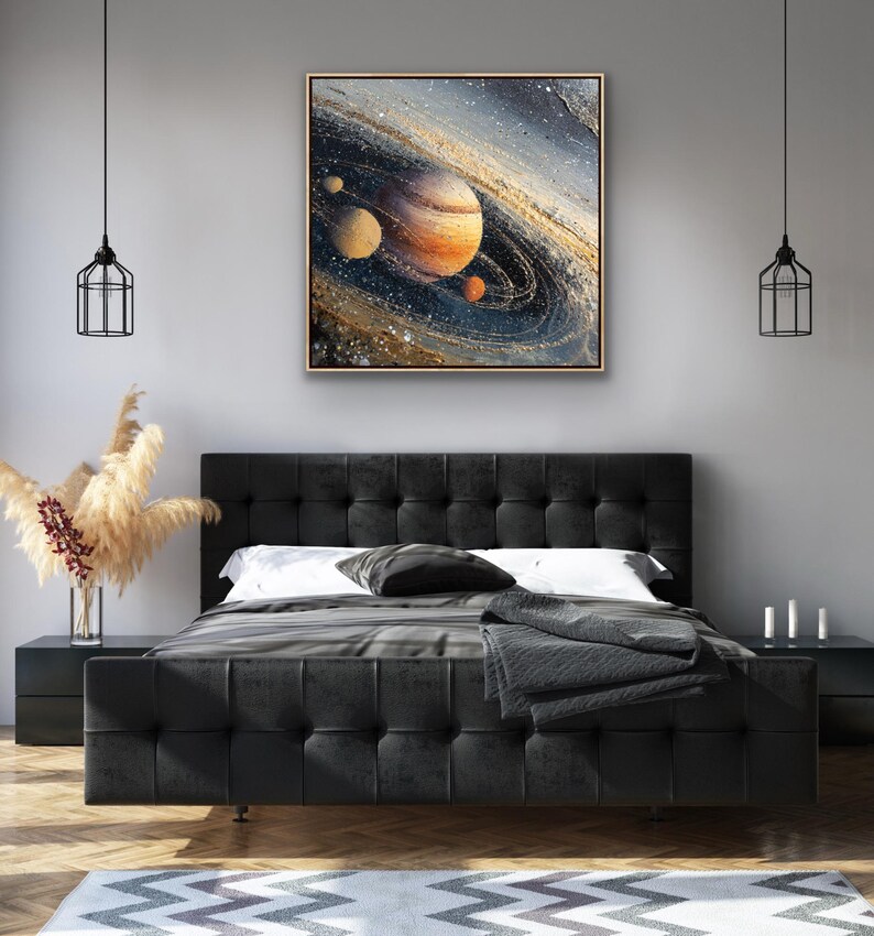 May include: A framed abstract painting of a planet with rings, in shades of orange, brown, and blue. The artwork is displayed above a black tufted bed with a gray blanket and pillows. The room has a modern design with black nightstands and pendant lights.