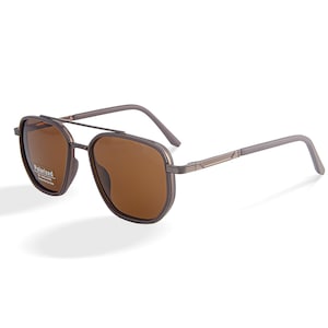 May include: Brown polarized sunglasses with a double bridge and a gray frame. The lenses are a warm brown color, and the frame has a rectangular shape. The sunglasses are designed for sun protection.
