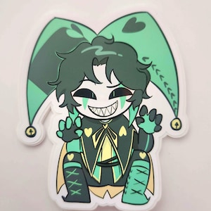 May include: A sticker featuring a cartoon jester character with green hair and a white face. The jester wears a green and black outfit with yellow accents, a pointed hat, and a wide, toothy grin. The sticker has a white border.