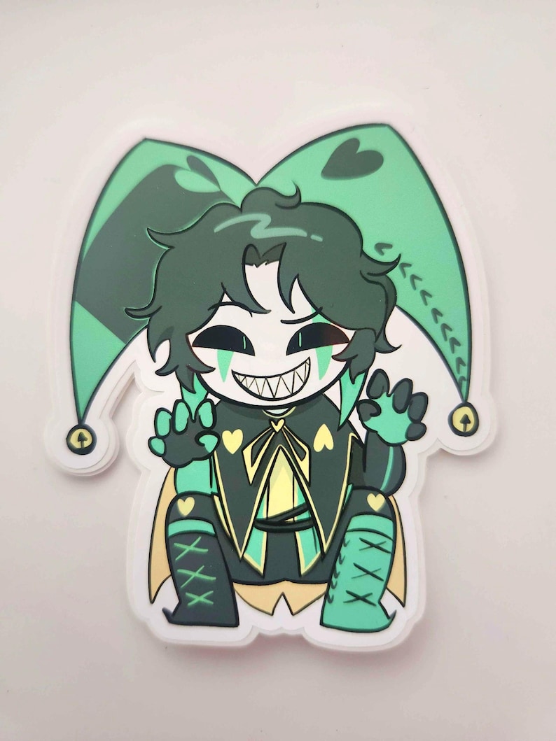 May include: A sticker featuring a cartoon jester character with green hair and a white face. The jester wears a green and black outfit with yellow accents, a pointed hat, and a wide, toothy grin. The sticker has a white border.