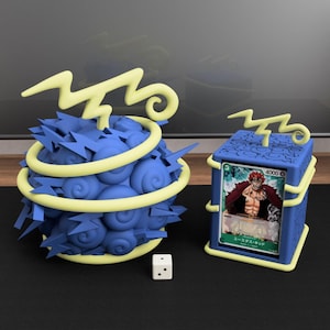 May include: A blue spherical container with a textured swirl pattern and yellow lightning bolt accents, a matching blue rectangular card holder with a yellow lightning bolt top, and a small white six-sided die with two black dots.