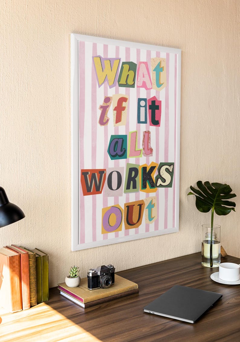 May include: A framed print with a pink and white striped background and the text "What if it all works out" in colorful, cut-out letters.