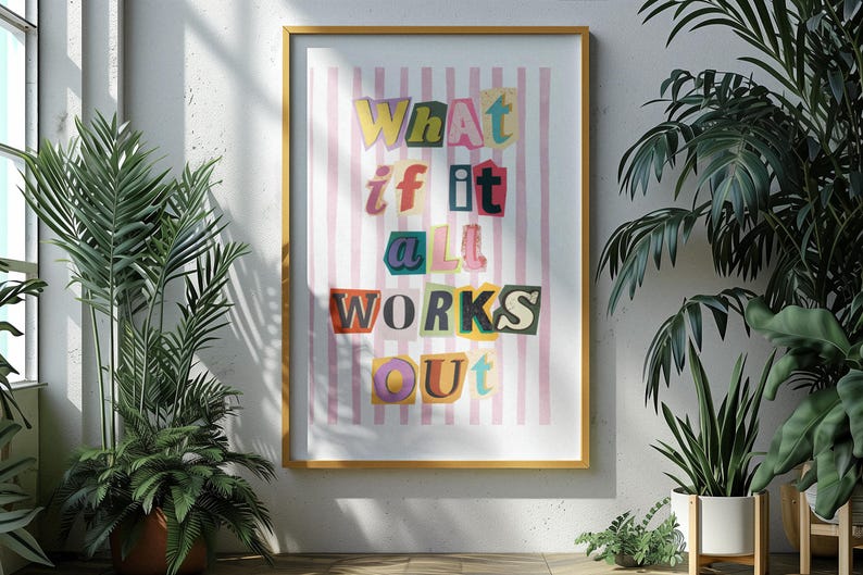 May include: A framed print with a pink and white striped background and the text "What if it all works out" in colorful, cut-out letters.