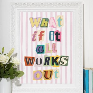 May include: A framed print with a pink and white striped background. The text "What if it all works out" is written in colorful, cut-out letters.