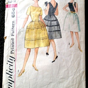 May include: Vintage Simplicity sewing pattern number 4595 for a dress. The pattern includes three different styles, one with a yellow skirt, one with a black skirt, and one with a white skirt. The pattern is for a size 12 with a bust size of 32 inches.