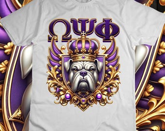 May include: White t-shirt featuring a regal bulldog design. The graphic includes a crown, wings, and the Greek letters Omega, Psi, and Phi in purple and gold. The bulldog has a stern expression.