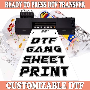 May include: A black DTF printer with a 22-inch print area is shown. The image features the text "DTF GANG SHEET PRINT" and "READY TO PRESS DTF TRANSFER" and "CUSTOMIZABLE DTF". Rolls of printed transfer sheets are visible.