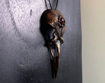 Bronze Crow Skull Pendant set with a Garnet
