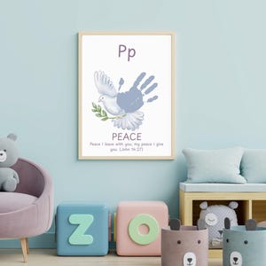 May include: A framed print featuring a dove with a handprint, the word "PEACE", and the text "Peace I leave with you, my peace I give you (John 5:27)". The artwork is displayed in a child's room with a light blue wall.