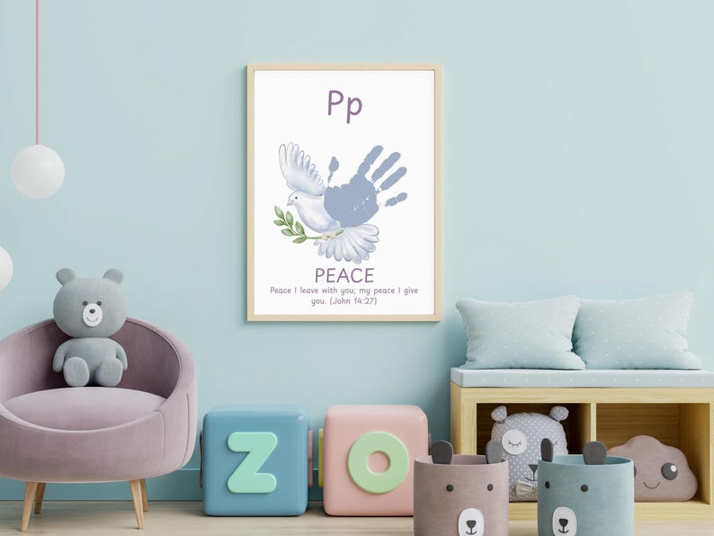 May include: A framed print featuring a dove with a handprint, the word "PEACE", and the text "Peace I leave with you, my peace I give you (John 5:27)". The artwork is displayed in a child's room with a light blue wall.