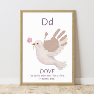 May include: A framed print featuring a white dove holding a pink flower in its beak. The dove's wing is made from handprints. The letter "D" and the word "DOVE" are at the top and bottom, with a Bible verse below.