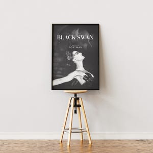 May include: Black and white movie poster for the film "Black Swan" starring Natalie Portman.