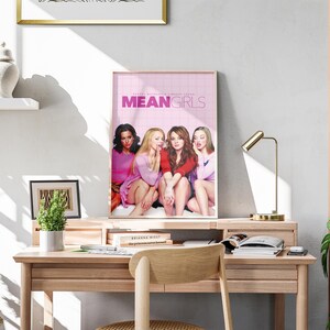 May include: A poster of the movie Mean Girls featuring four women in pink and red clothing. The poster has a pink background with the title "Mean Girls" in white text.