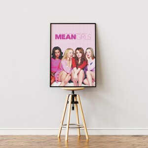 May include: A movie poster for the film "Mean Girls" featuring four young women in pink and red clothing. The poster has a pink background with the title "Mean Girls" in white letters.