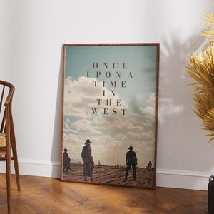 May include: A vintage-style poster with a faded blue sky and white clouds. The text "ONCE UPON A TIME IN THE WEST" is printed in brown letters. Three figures in silhouette stand in the distance.