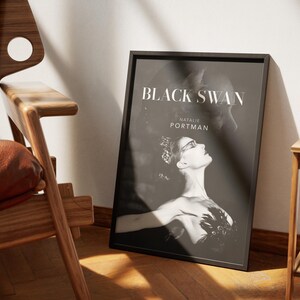 May include: Black and white poster with the title "Black Swan" and the name "Natalie Portman" in white text. The poster features a black and white image of a ballerina in a black swan costume.