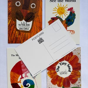 May include: A collection of Eric Carle postcards featuring illustrations from his children's books. The postcards include images of a lion, a rooster, a chameleon, and a flower. One postcard is blank, with lines for writing.