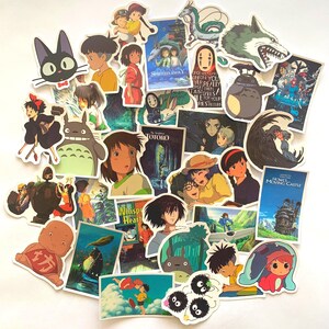 May include: A collection of colourful stickers featuring characters and scenes from popular Studio Ghibli films, including Totoro, Spirited Away, Howl's Moving Castle, and Kiki's Delivery Service.