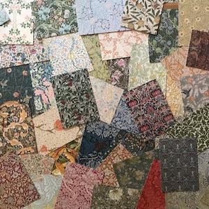 May include: A collection of patterned paper squares in various colors and designs, including floral, geometric, and abstract patterns. The papers are arranged in a random pattern, creating a visually interesting and textured surface.