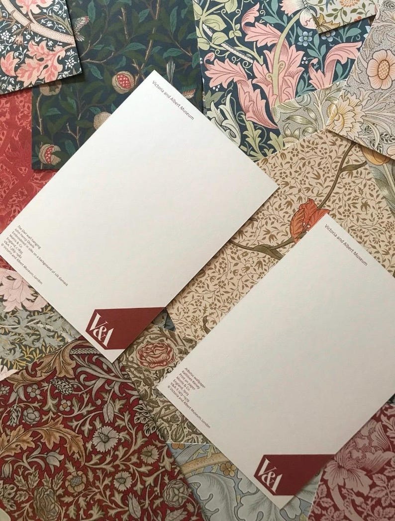 May include: Two white letterheads with the Victoria and Albert Museum logo and text. The letterheads are on top of a variety of patterned papers with floral designs in shades of red, blue, green, and brown.