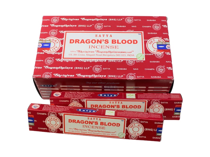 May include: A box and two packs of Satya Dragon's Blood incense sticks. The box is red with white text and the packs are red with white and blue text. The text on the box and packs reads "Satya Dragon's Blood Incense" and "Shrinivas Sugandhalaya (BNG) LLP".