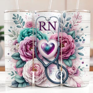 May include: A white tumbler featuring a floral design and a stethoscope with a heart and the letters "RN" on it.