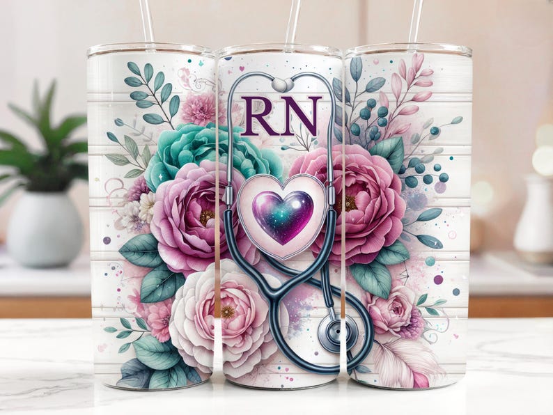 May include: A white tumbler featuring a floral design and a stethoscope with a heart and the letters "RN" on it.