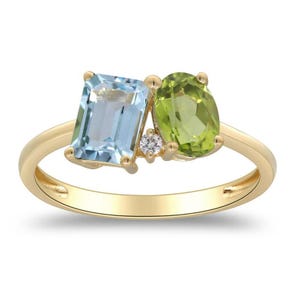 May include: A gold ring with an emerald-cut, light blue gemstone and an oval, light green gemstone. A small, round, clear gemstone is set between the two larger stones. The ring has a simple, polished band.