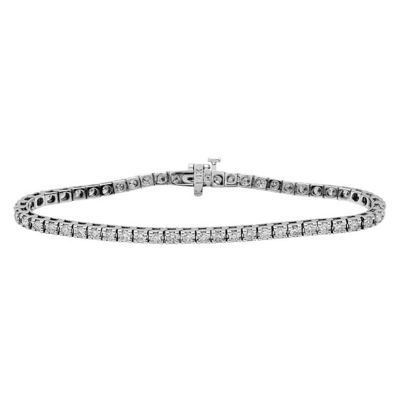 May include: A delicate silver tennis bracelet featuring a row of small, sparkling diamonds. The bracelet has a secure clasp and is designed for a comfortable fit. This elegant piece of jewelry is perfect for adding a touch of sparkle to any outfit.