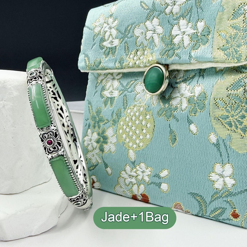 May include: A silver bracelet with rectangular jade stones and floral accents, next to a teal clutch with a floral pattern and a jade clasp. The text "Jade+1Bag" is at the bottom.