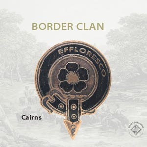 May include: A bronze-colored Cairn clan crest with the text "Effloresco" around the edge. The crest features a black flower with a gold center and a black and gold design.