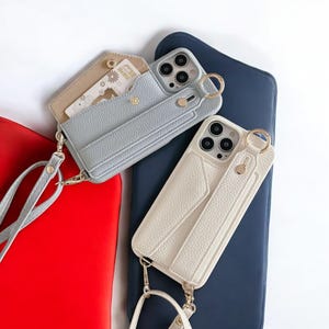 Funda de cuero tipo billetera con anilla, ranura para tarjetas, correa para la muñeca y cordón cruzado para iPhone 11-16 Pro Max