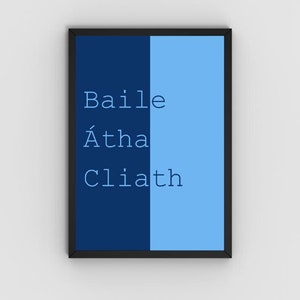 May include: A framed print with a dark blue background and a light blue background. The text "Baile Átha Cliath" is printed in white on the dark blue background.