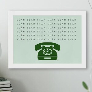 May include: A framed print with a green vintage rotary phone illustration and the text "SLAN SLAN SLAN SLAN SLAN SLAN NYTS NYTS NYTS NYTS NYTS NYTS SLAN SLAN SLAN SLAN SLAN SLAN SLAN SLAN SLAN SLAN SLAN SLAN SLAN SLAN SLAN SLAN SLAN SLAN SLAN" repeated on a light green background.