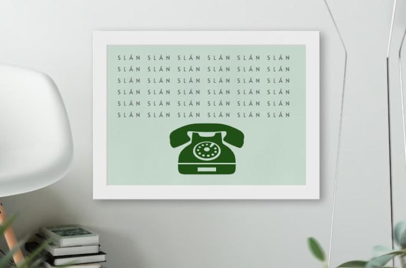 May include: A framed print with a green vintage rotary phone illustration and the text "SLAN SLAN SLAN SLAN SLAN SLAN NYTS NYTS NYTS NYTS NYTS NYTS SLAN SLAN SLAN SLAN SLAN SLAN SLAN SLAN SLAN SLAN SLAN SLAN SLAN SLAN SLAN SLAN SLAN SLAN SLAN" repeated on a light green background.