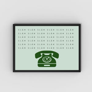 May include: A framed print with a light green background and a dark green vintage rotary phone illustration. The text "SL&Aacute;N SL&Aacute;N SL&Aacute;N SL&Aacute;N SL&Aacute;N SL&Aacute;N SL&Aacute;N SL&Aacute;N SL&Aacute;N SL&Aacute;N SL&Aacute;N SL&Aacute;N SL&Aacute;N SL&Aacute;N SL&Aacute;N SL&Aacute;N SL&Aacute;N SL&Aacute;N SL&Aacute;N SL&Aacute;N SL&Aacute;N SL&Aacute;N SL&Aacute;N SL&Aacute;N SL&Aacute;N SL&Aacute;N" is repeated in a column down the left side of the print.