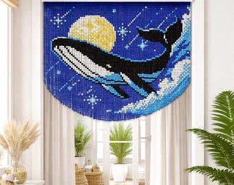 May include: A beaded curtain featuring a whale leaping from ocean waves under a full moon and starry night sky. The whale is black, white, and blue against a deep blue background. Decorative home decor.