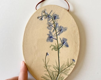 Botanical ceramic wall hanging with hand painted blue delphinium imprint, a rustic pottery wall hanging for farmhouse decor