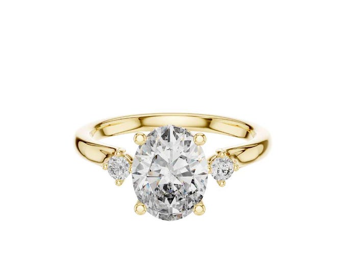 Radiant Trio Unique Three-Stone Oval Diamond Ring with Sparkling Pave Accents on Warm Gold A Distinctive Celebration of Love and Elegance