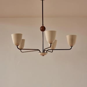 May include: A five-light chandelier with a brown metal frame and off-white glass shades. The chandelier has a simple, modern design.