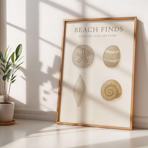 May include: A framed print titled "Beach Finds Coastal Collection" displaying illustrations of seashells. The artwork shows a sand dollar, an oval shell, a long shell, and a spiral shell, in neutral tones. The frame is made of light brown wood.