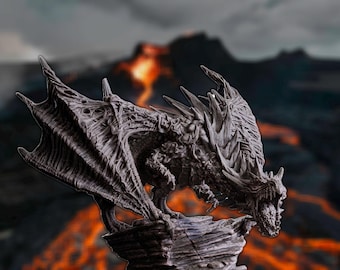 May include: A detailed, gray dragon sculpture with textured wings and scales, perched on a rocky base. The dragon is set against a blurred background of a volcanic landscape with flowing lava, creating a fantasy theme.