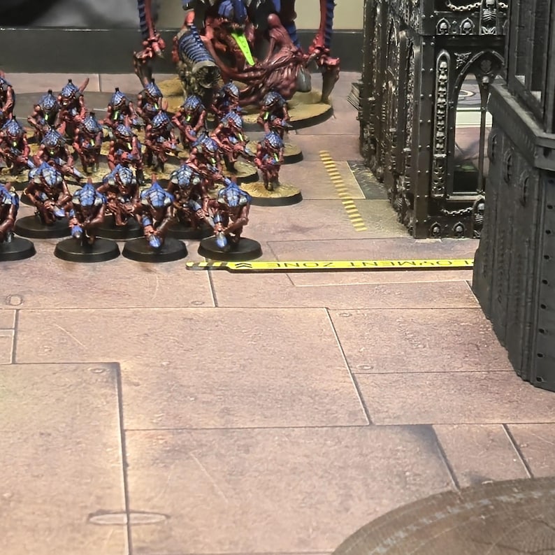 Tyranid army standing behind yellow deployment guide on a warhammer 40k table