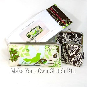 May include: A kit to make your own clutch bag. The kit includes instructions, fabric, and hardware. The fabric is a floral print with green birds and brown accents. The hardware is silver.