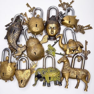 May include: A collection of 10 ornate brass padlocks, each featuring a different animal design. The padlocks are intricately detailed and have a vintage aesthetic. The animals include a fish, turtle, elephant, deer, horse, camel, and Buddha.